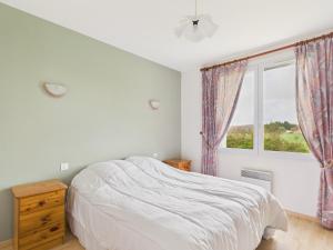 Séjour à la campagne pour 6 في Commequiers: غرفة نوم بيضاء مع سرير ونافذة