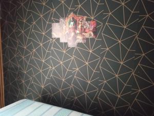 a room with a black and white geometric wallpaper at Camping estrela Ubatuba in Ubatuba