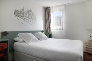 a bedroom with a white bed with a drawing on the wall at Hotel Restaurant Isidore by Soniho in Nice