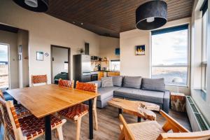 a living room with a table and a couch at Blue View Cabins in Reykholt