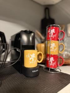 two coffee mugs sitting on top of a counter at RHODESIA guest house in Chalkida