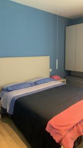 a bedroom with a large bed and a tv at Appartamento L'Aurora in Gabicce Mare