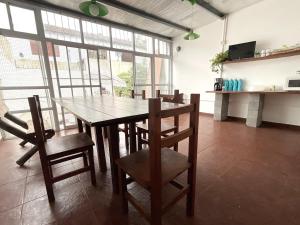 a dining room with a wooden table and chairs at Morada del Sol in San Bernardo