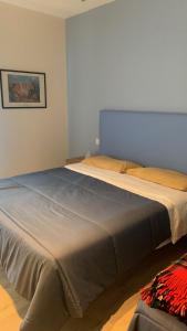 a bedroom with a large bed in a room at Appartamento L'Aurora in Gabicce Mare +10 photos