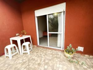 a patio with a table and two stools next to a window at Morada del Sol in San Bernardo +4 photos