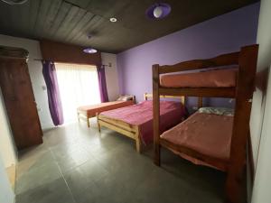 a bedroom with two bunk beds and a window at Morada del Sol in San Bernardo