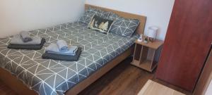 a bedroom with a bed with two pillows on it at Divčibare Snežna Kraljica ap 13 in Divčibare +42 photos