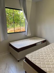 Ένα ή περισσότερα κρεβάτια σε δωμάτιο στο Estância da Colina Chalet +5 φωτογραφίες