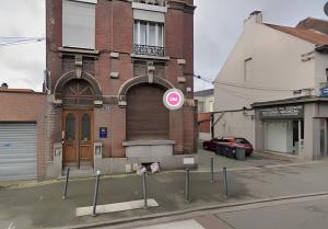 a brick building with a sign in front of it at Capsule Roubaix/Lille Balneo*Home cinéma*Billard in Roubaix