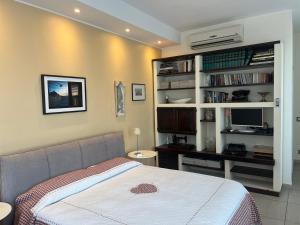a bedroom with a bed and a desk with a computer at Villa Varenna in Varenna