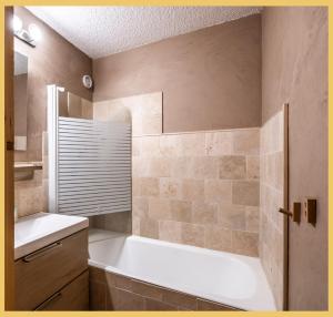 a bathroom with a bath tub and a sink at L'Alpenlake I Studio I Châtel in Châtel +23 photos