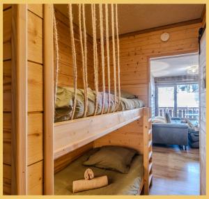 a bedroom with two bunk beds in a wooden cabin at L'Alpenlake I Studio I Châtel in Châtel
