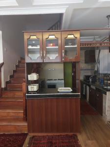a kitchen with a counter and a staircase at Yukis & Kukis Place, 5 bedrooms, 5 bathrooms, 2 Sitting Rooms in Embu
