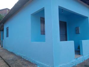 a blue and white building with two windows at Casa simples em cunha in Cunha +19 photos