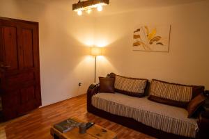 a living room with a couch and a table at FoRest Apartment 