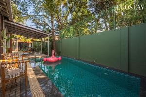 a swimming pool with a red inflatable raft in a house at EKOSTAY - Assa Villa in Marna