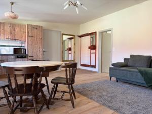 a kitchen and living room with a table and a couch at Gasthof Krone Fladungen in Fladungen