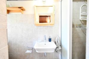 a bathroom with a sink and a mirror at Villa Easternwind in Pointe d'Esny +65 photos