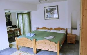 a bedroom with a bed and a desk and a television at Chesa Tre Piz in Maloja