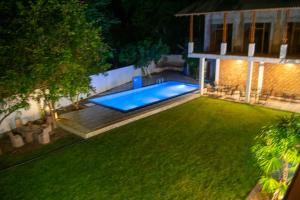 an image of a backyard at night with a swimming pool at Ovenro Safari Hotel & Restaurant Yala, Kataragama in Kataragama