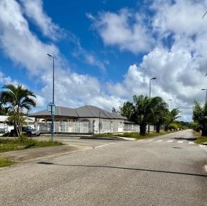 an empty street in front of a building at La maison blanche in Macouria