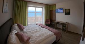 Una habitación de hotel con una cama y una ventana. en Hotel-Gasthof Lammersdorf, en Millstatt