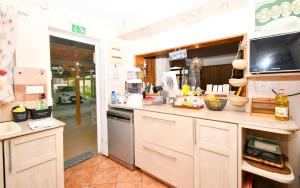 a kitchen with white cabinets and a counter top at Villa Easternwind in Pointe d'Esny