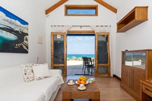 a living room with a white couch and a table at Blue Horizon Coast By PVL in Punta de Mujeres
