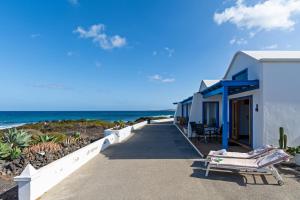 a building on the beach next to the ocean at Blue Horizon Coast By PVL in Punta de Mujeres