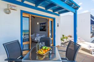 a table with a bowl of fruit on a patio at Blue Horizon Coast By PVL in Punta de Mujeres +10 photos