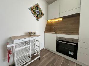 a small kitchen with a sink and a stove at Pietre al Sole di Sicilia in Modica +4 photos