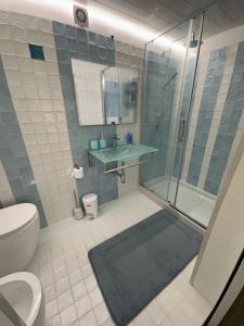 a bathroom with a shower and a sink and a toilet at Pietre al Sole di Sicilia in Modica