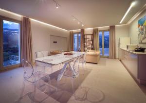 a kitchen and living room with a table and chairs at Suite Home Villas with Private Pools by Explore Andros in Andros
