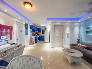 a living room with a couch and a table at Garden Condo in Sosúa