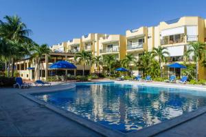 a swimming pool in front of a resort at Garden Condo in Sosúa