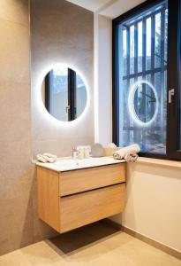 a bathroom with a sink and a mirror at Appartement Chalet Saalbach in Saalbach Hinterglemm