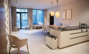 a kitchen and living room with a counter and chairs at Appartement Chalet Saalbach in Saalbach Hinterglemm +19 photos