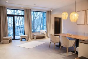 a living room with a dining room table and chairs at Appartement Chalet Saalbach - incl Joker Card in Saalbach-Hinterglemm