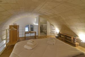ein Schlafzimmer mit einem großen Bett, auf dem Handtücher liegen in der Unterkunft aMate' Luxury slow living by BarbarHouse in Matera