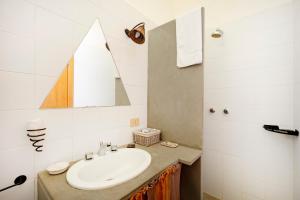 a bathroom with a sink and a mirror at Villa Ada in Cozze
