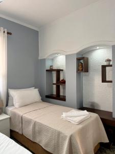 a bedroom with a large bed with white sheets at Villa CTT in Tirana