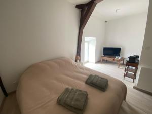 a bedroom with a bed with two pillows on it at Chez Simone et Marguerite in Luzy