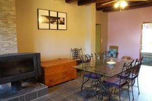 a living room with a table and a television at Chambre 1 , Maison d'Hôtes du Holley in Xivry-Circourt