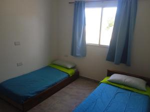 En eller flere senge i et værelse på Piquillin San Lorenzo