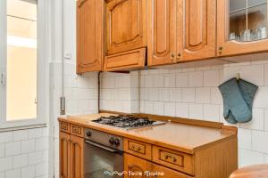 a kitchen with wooden cabinets and a stove top oven at Tik Tok, TerreMarine in Bonassola