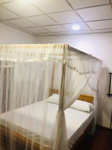 a bedroom with a bed with a canopy at Chill corner in Ahangama
