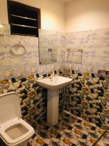 a bathroom with a sink and a toilet at Chill corner in Ahangama