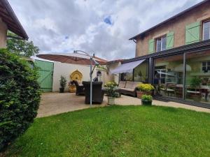 patio con ombrellone in cortile di Au fil du temps 54 a Lironville