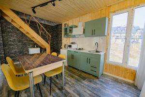 a kitchen and dining room with a table and chairs at Snow Heaven for 10 in Gudauri +16 photos