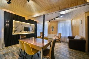 a dining room with a table and chairs at Snow Heaven for 10 in Gudauri